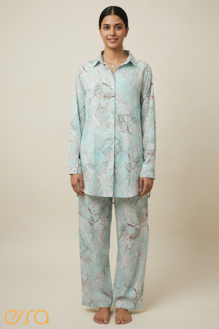 Optimize your image with: "Woman wearing a mint teal and rose gold marble digital print co-ord set with oversized shirt and trousers