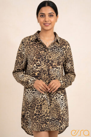 Woman wearing a leopard print long-sleeve button-down shirt dress