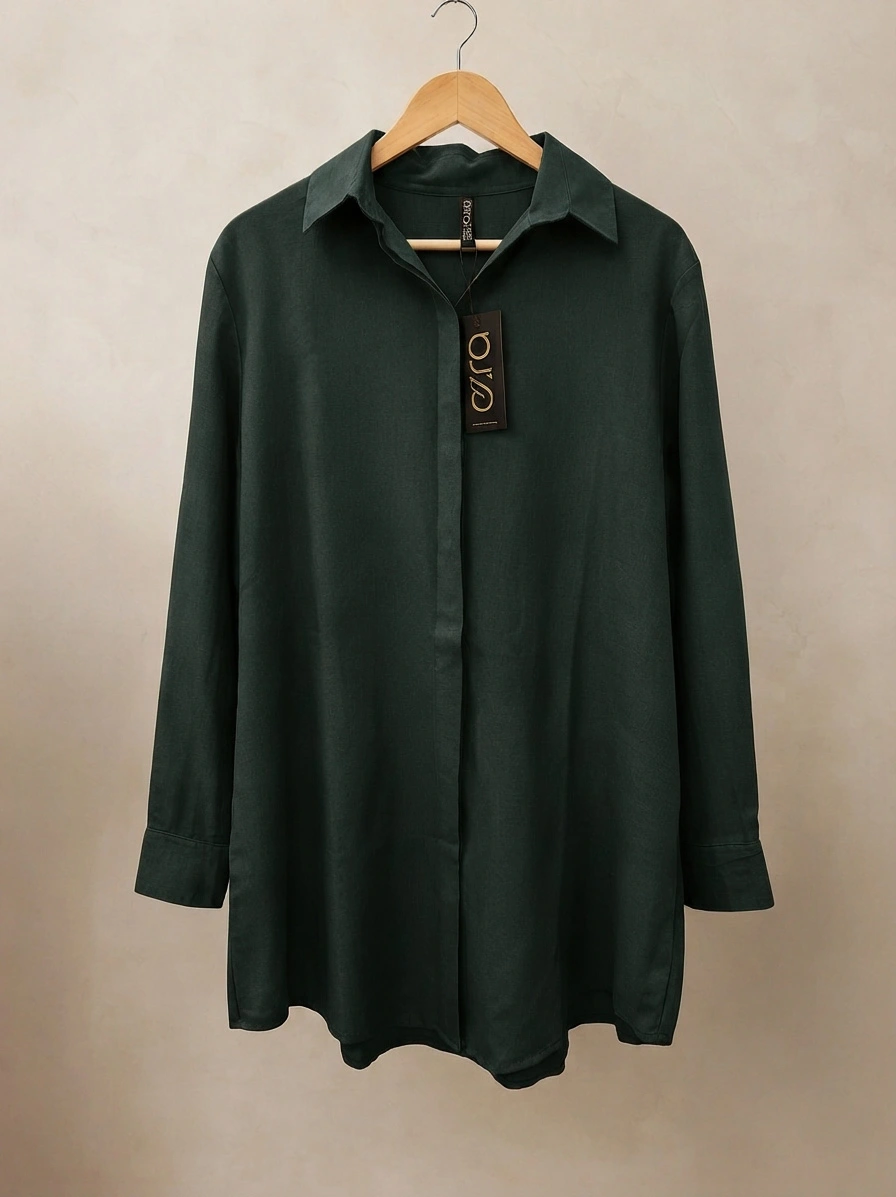 Dark green long-sleeve button-down shirt with a classic collar hanging on a wooden hanger against a neutral background.