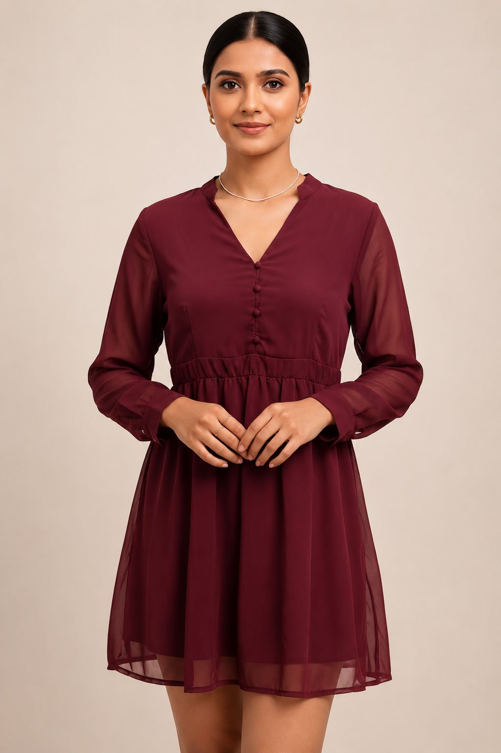 Model wearing a solid maroon women's dress with long sleeves, a V-neck, and front button details.